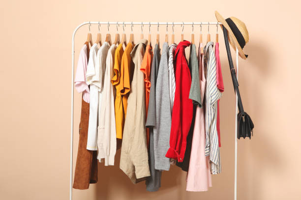 istock Fashionable clothes on hangers on a wardrobe rack. 1279620082