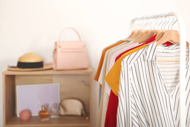 istock Fashionable clothes on hangers on a wardrobe rack. 1279620710