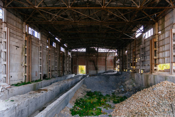 istock Abandoned ruined large industrial hall with garbage waiting for demolition 1279620782