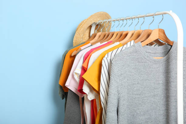 istock Fashionable clothes on hangers on a wardrobe rack. 1279620817