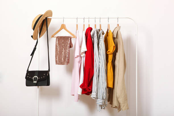 istock Fashionable clothes on hangers on a wardrobe rack. 1279620956