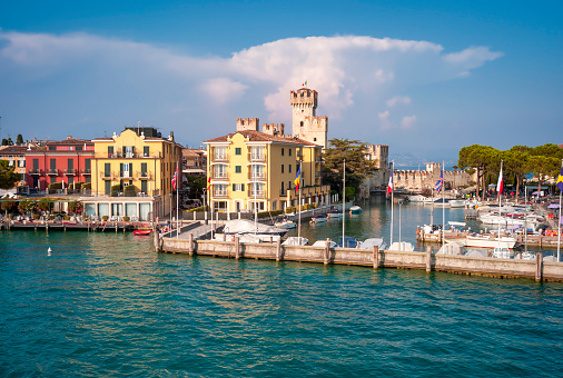 The touristic marina of Sirmione, over the shores of Garda Lake (Lombardy, Northern Italy), during summertime.