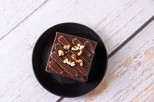 chocolate cakes on white ceramic plate with nuts topping