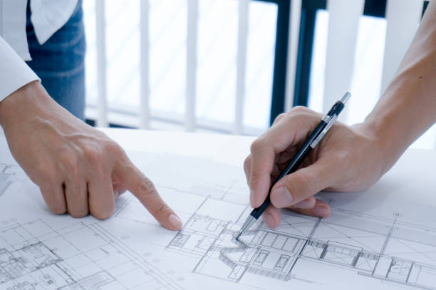 istock Colleagues interior designer Corporate Achievement Planning Design on blueprint Teamwork Concept with compasse. 1279623979