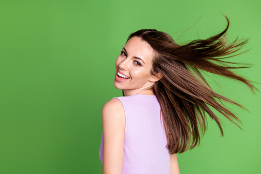 Close-up profile side view portrait of her she nice attractive pretty charming, lovely cheerful cheery girl enjoying holiday St. Patrick's Day wind throwing hair isolated over green color background