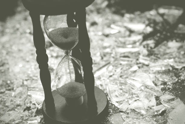 istock Sand clock on broken glass pieces in blur. 1279630939
