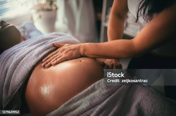 Pregnant Woman Having Massage In Spa Relax Stock Photo - Download Image Now - Massaging, Pregnant, Abdomen