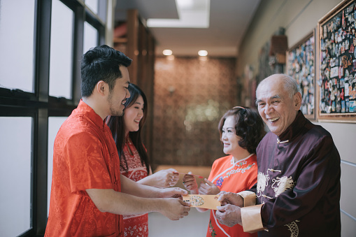 asian chinese family with traditional clothing celebrating chinese new year reunion dinner
