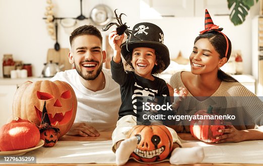 istock Happy multi ethnic family preparing for Halloween celebration 1279635259