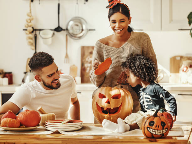 istock Happy multi ethnic family preparing for Halloween celebration 1279635338