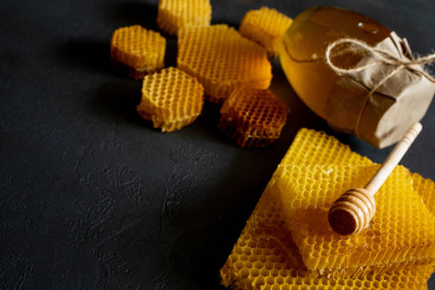 istock Jar of honey with honeycomb on black table, top view. space for text 1279636366