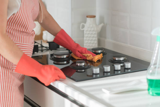istock Women is cleaning modern black induction stove. 1279637641