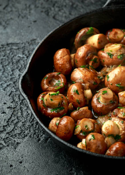 istock Fried mushrooms with onion and garlic in iron cast pan 1279639485