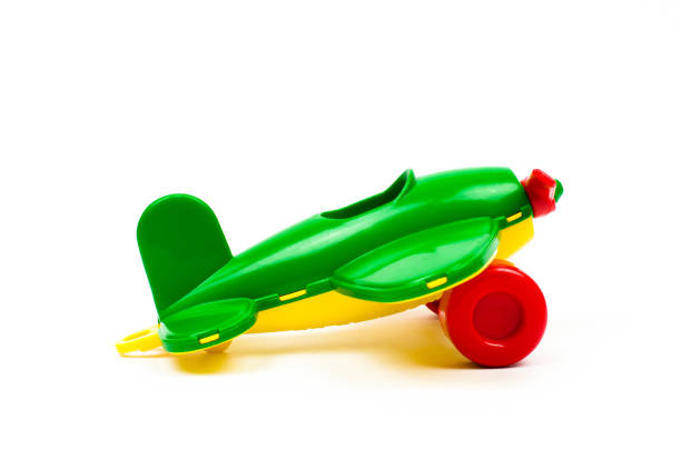 Children's toy plane of green color on a white background Children's toy plane of green color on a white background. Kids toys. toy airplane stock pictures, royalty-free photos & images