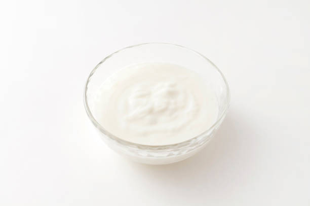 istock Yogurt in a glass bowl on white background 1279640680