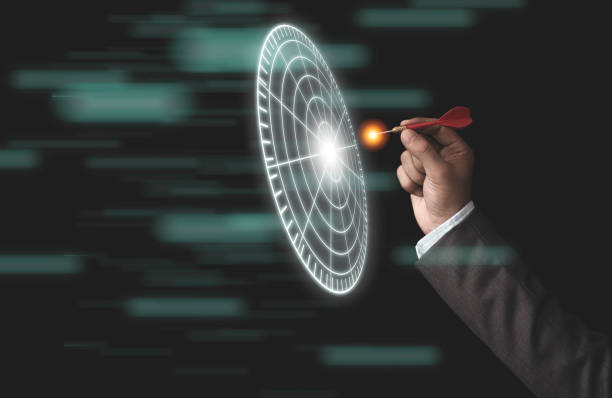 istock Businessman throwing red arrow dart to virtual target dart board. Setup objectives and target for business investment concept. 1279640960