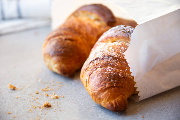 Fresh baked sweet croissants with jam or honey for breakfast