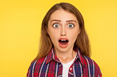 Wow, unbelievable! closeup caricature comic portrait of shocked or surprised funny young woman looking at camera with open mouth and amazed big eyes.