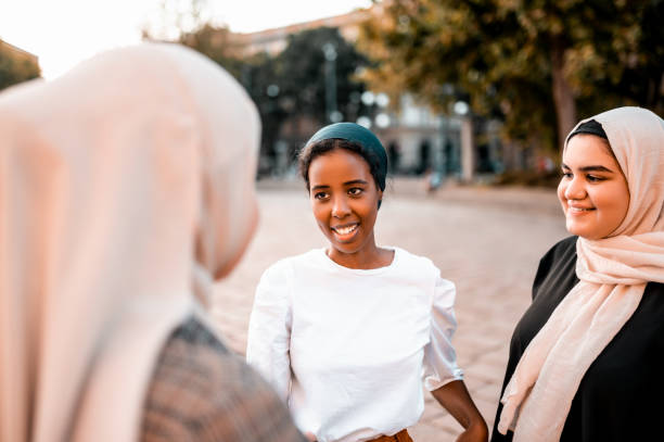 istock Young women standing at the town square and talking 1279643297