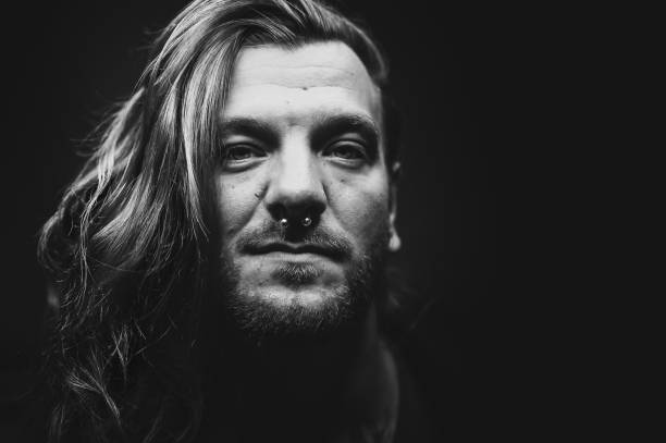 istock Man with long hair looks seriously at the camera 1279644991