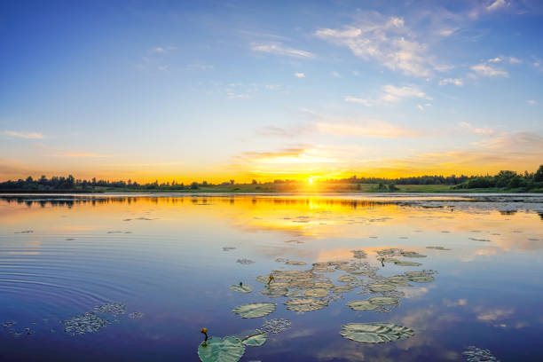 Beautiful landscape with colorful sunrise over lake