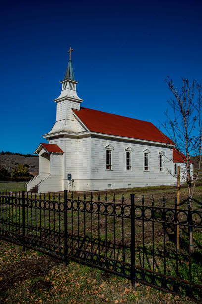 istock Nicasio, CA white wooden church with blue sky 1279647768