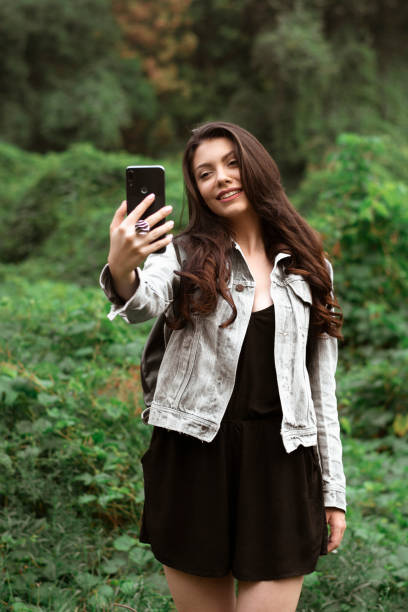 istock Beautiful girl taking selfies in the nature. 1279648043