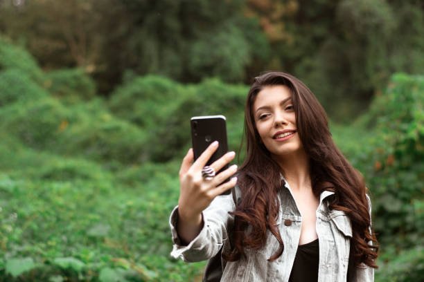 istock Hipster girl taking selfies while exploring the nature. 1279649036