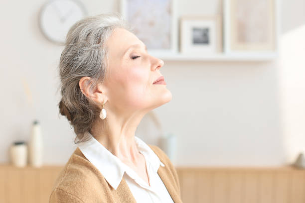 istock Attractive middle aged woman relaxing in sofa at home. 1279649063