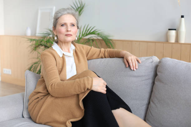 istock Attractive middle aged woman relaxing in sofa at home. 1279649182