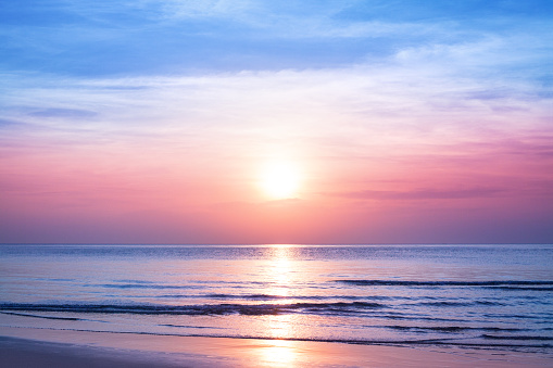 Beautiful morning sunrise, blue sea, pink sky, white clouds, yellow sun glow, golden reflection on water, peaceful landscape, quiet sunset on ocean beach, dawn seascape, Thailand, Koh Samui island