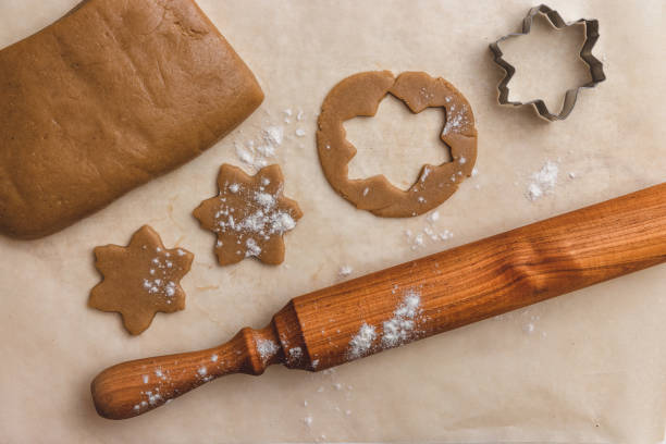 istock rolling pin, star shaped metal baking dish, ginger dough on craft paper, process of making homemade cakes 1279650255