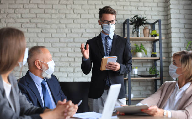 istock Business team in protective masks works in the office. 1279650546