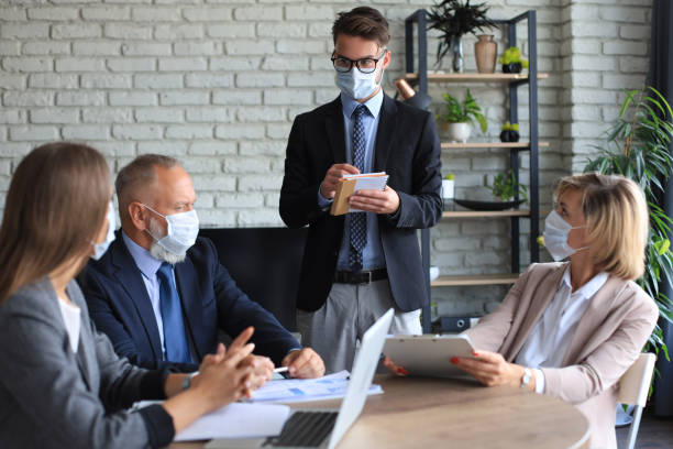 istock Business team in protective masks works in the office. 1279651180