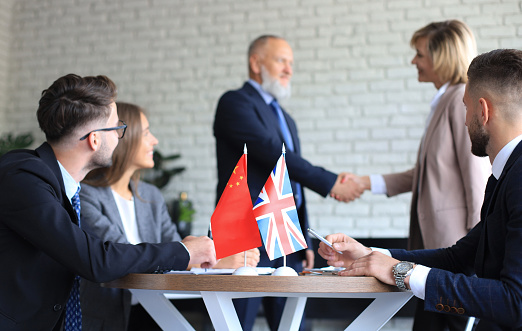 United Kingdom and Chinese leaders shaking hands on a deal agreement