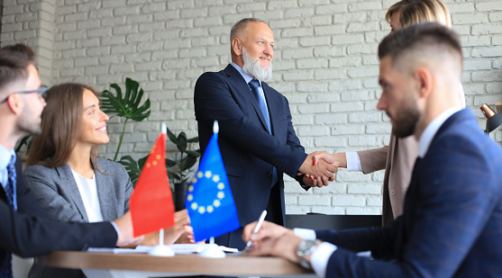 European Union and Chinese leaders shaking hands on a deal agreement