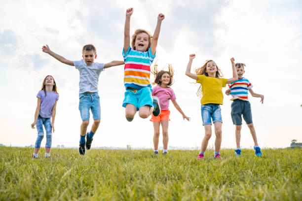 istock Group of kids jumping in nature 1279651459