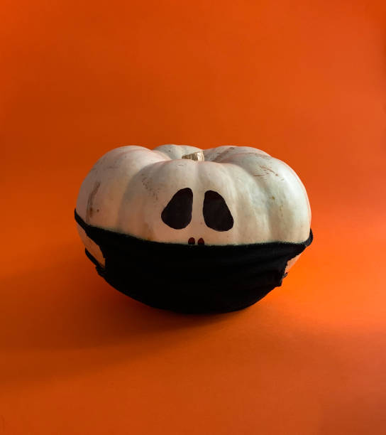 istock Covid-19 pumpkin in Halloween wearing black protective mask 1279651588