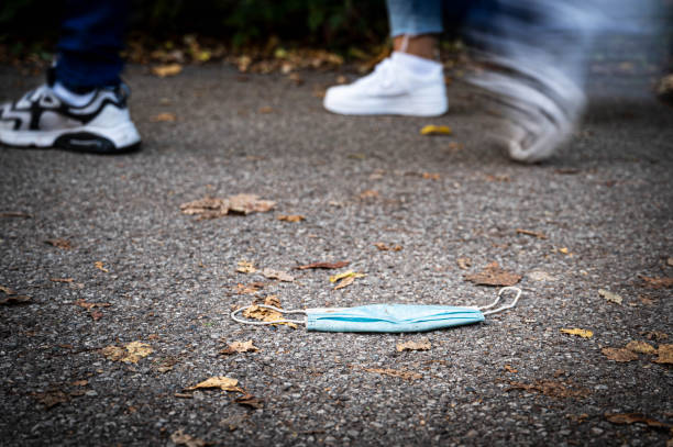 istock Runners passing a Covid-19 face mask on the street 1279651731