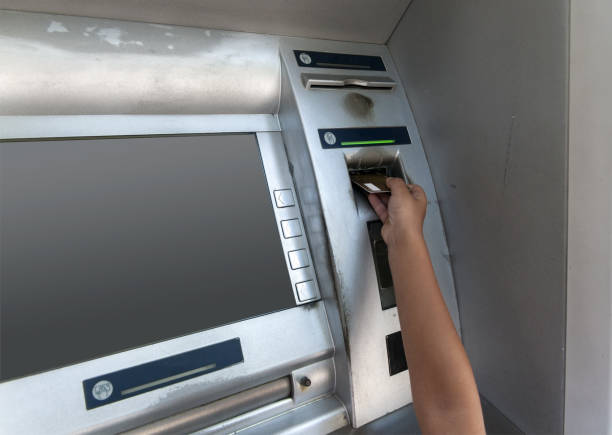 istock hand of a boy pokes a card at an ATM 1279651984