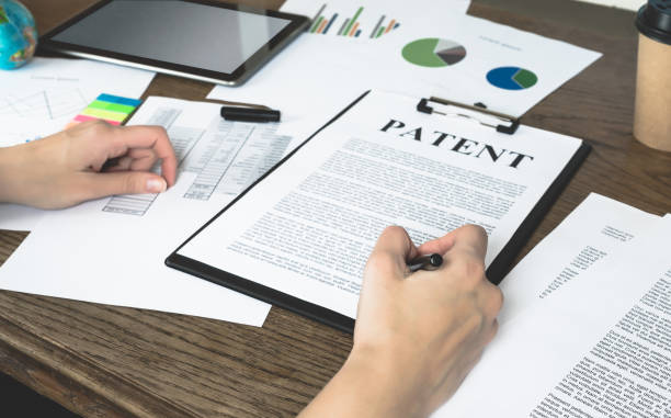 Business woman signs a patent. Intellectual property protection concept. Patent attorney. Business woman signs a patent. Intellectual property protection concept. trademark stock pictures, royalty-free photos & images
