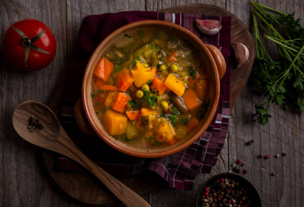 istock Vegetable soup with parsley on dark background 1279652780