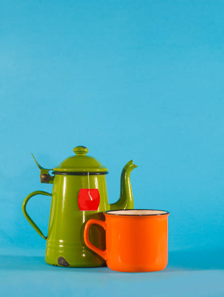 istock Vintage teacup and orange cup on blue background. Copy space on top 1279656626