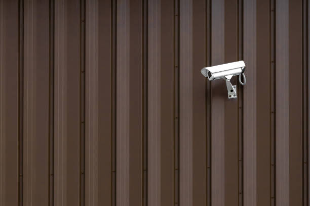 istock Building with Surveillance or Security Camera on metal brown wall, corrugated texture, galvanized steel surface, Abstract architectural pattern for background with copy space 1279656651
