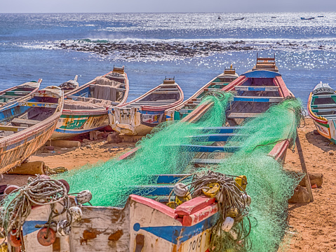 Dakar, Senegal - February 2, 2019: Colored, wooden, fisher  boats on the sandy beach of Dakar,   Africa