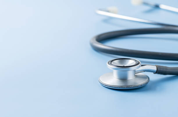 istock Old medical stethoscope on blue background. 1279660745