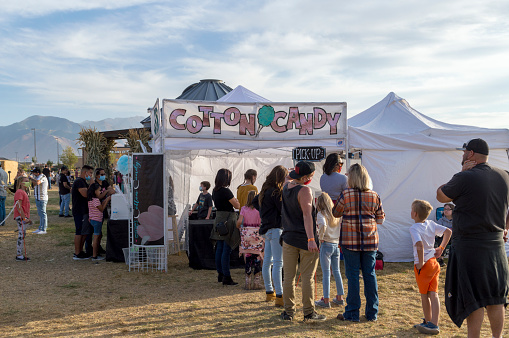 October 10, 2020 - Springville, Utah, USA: This Cotton Candy stand is set up at a pumpkin patch is full of customers picking out pumpkins for carving Halloween Jack O' Lanterns.  This pumpkin patch also has a variety of autumn related activities for customers to enjoy