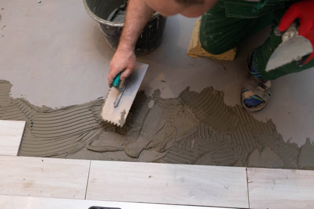 istock Laying terracotta in the bathroom. Builder during work. Adhesive for ceramic tiles. 1279663537