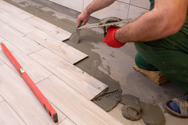 istock Laying terracotta in the bathroom. Builder during work. Adhesive for ceramic tiles. 1279664132