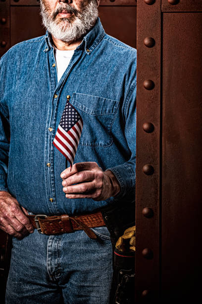 istock A male construction worker holding a small US Flag 1279665847
